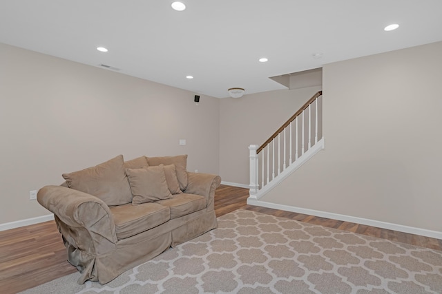 living room with baseboards, recessed lighting, wood finished floors, and visible vents