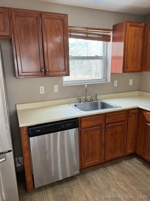 36 Meadowrue Dr Unit 36, Glastonbury, CT 06033 - kitchen featuring a sink, light wood-style flooring, light countertops, and appliances with stainless steel finishes