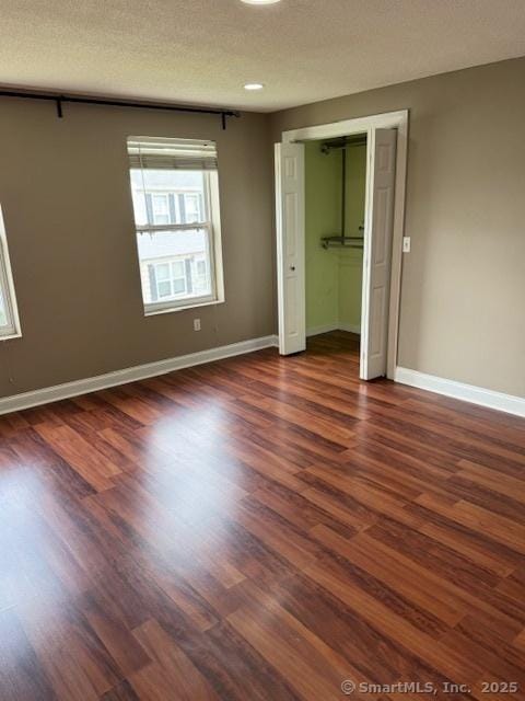 36 Meadowrue Dr Unit 36, Glastonbury, CT 06033 - unfurnished bedroom with baseboards and dark wood-style floors