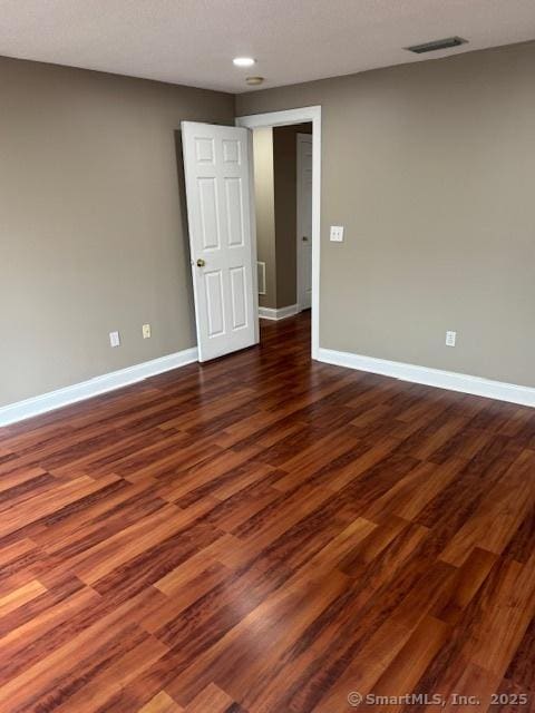 36 Meadowrue Dr Unit 36, Glastonbury, CT 06033 - unfurnished room featuring baseboards, dark wood-type flooring, and visible vents
