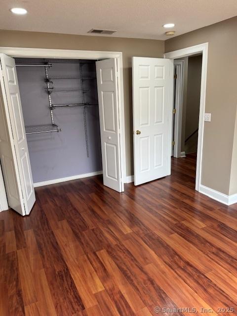 36 Meadowrue Dr Unit 36, Glastonbury, CT 06033 - unfurnished bedroom with wood finished floors, a closet, visible vents, baseboards, and recessed lighting