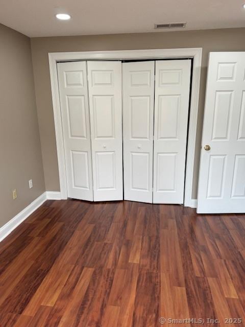 36 Meadowrue Dr Unit 36, Glastonbury, CT 06033 - unfurnished bedroom with a closet, visible vents, dark wood-style flooring, baseboards, and recessed lighting