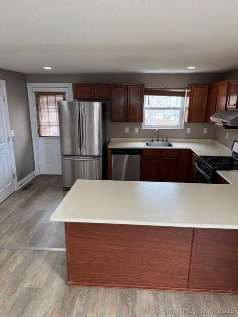 36 Meadowrue Dr Unit 36, Glastonbury, CT 06033 - kitchen featuring light countertops, stainless steel appliances, range hood, and a sink