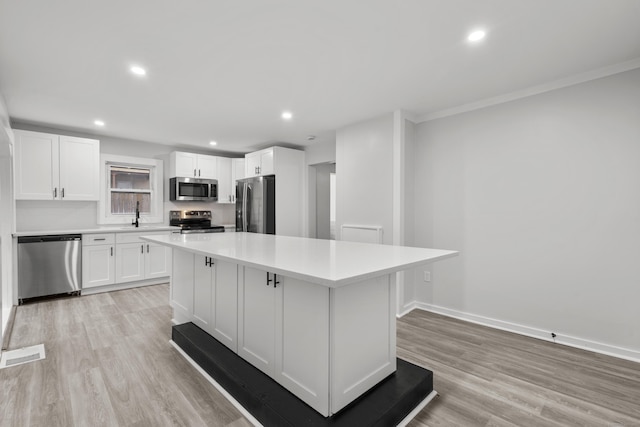 18 Brook St, Shelton, CT 06484 - kitchen with stainless steel appliances, visible vents, light countertops, white cabinets, and a kitchen island