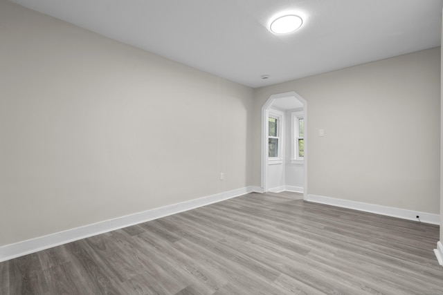 18 Brook St, Shelton, CT 06484 - empty room with arched walkways, baseboards, and wood finished floors