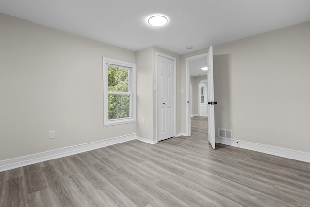 18 Brook St, Shelton, CT 06484 - unfurnished bedroom with baseboards, visible vents, and wood finished floors