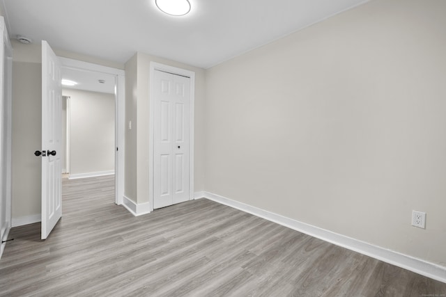 18 Brook St, Shelton, CT 06484 - unfurnished bedroom featuring a closet, light wood-style flooring, and baseboards