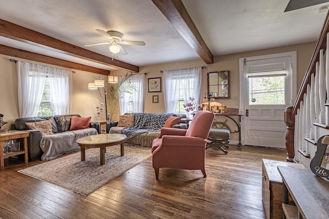 living area with plenty of natural light, ceiling fan, and beam ceiling