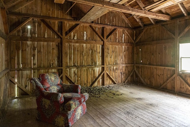 misc room featuring wood walls, lofted ceiling, and hardwood / wood-style flooring