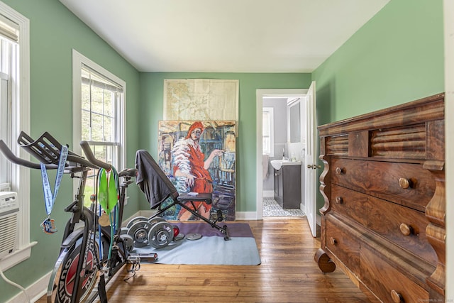 exercise area featuring baseboards and hardwood / wood-style floors