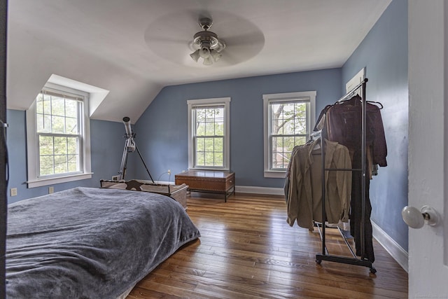 bedroom with baseboards, ceiling fan, lofted ceiling, and hardwood / wood-style floors