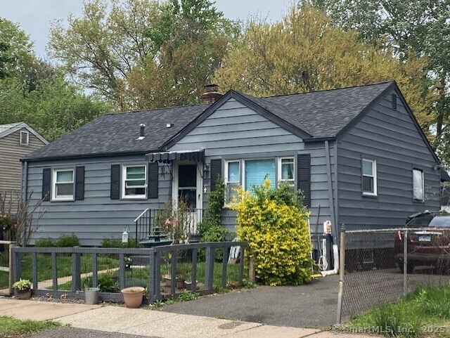 142 Yale St, Hartford, CT 06106 - view of front of home with a chimney, a fenced front yard, and roof with shingles