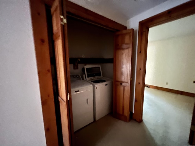 clothes washing area featuring laundry area and washer and clothes dryer