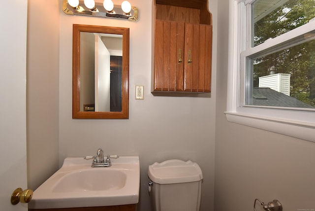 half bathroom with toilet and vanity