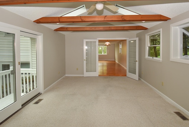empty room with french doors, carpet flooring, and baseboards