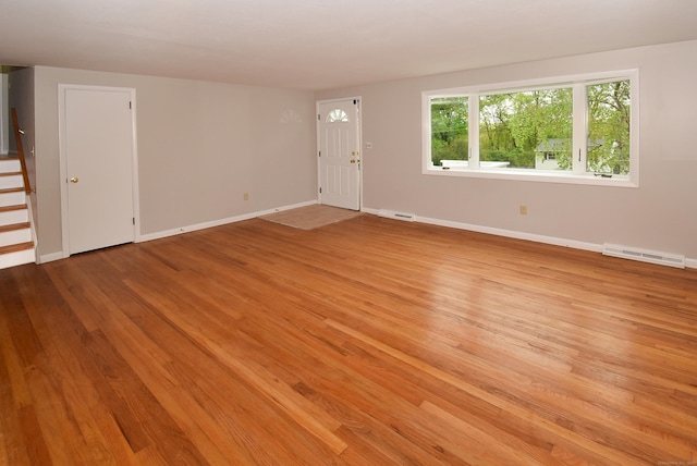 unfurnished room featuring light wood finished floors and baseboards