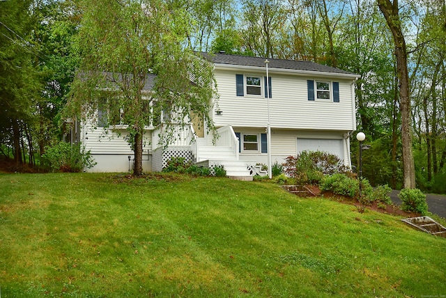 rear view of property featuring a garage and a yard
