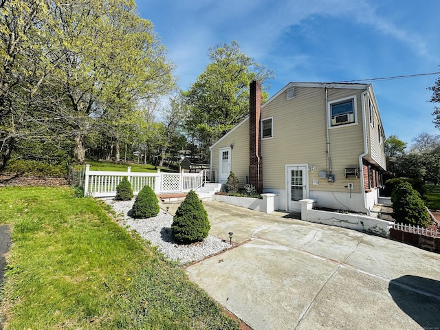 5 N Ridgeland Rd, Wallingford, CT 06492 - rear view of house featuring a yard, a chimney, and a patio