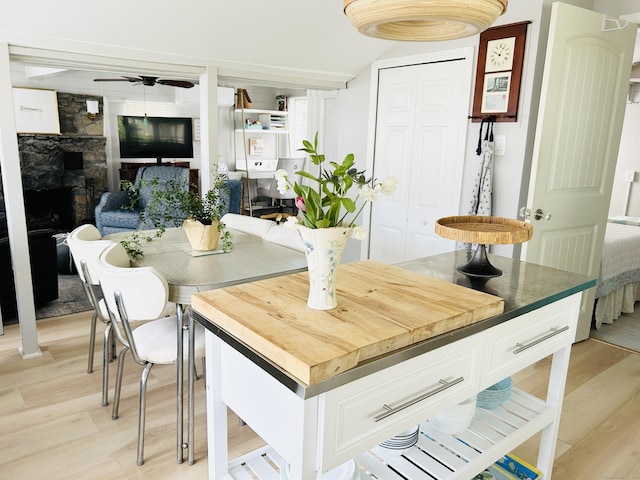 1 4th St, Madison, CT 06443 - kitchen featuring light wood-type flooring, ceiling fan, white cabinets, and wood counters