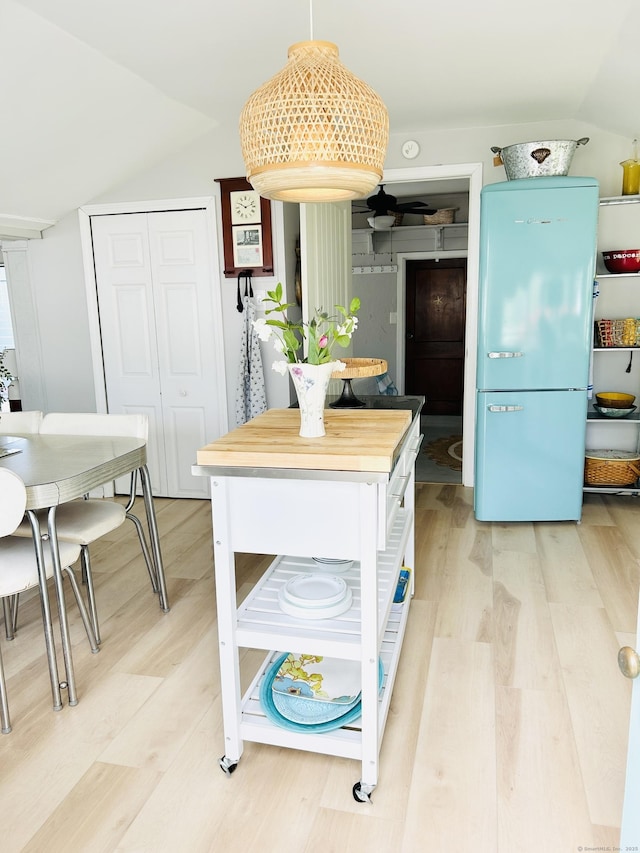 1 4th St, Madison, CT 06443 - kitchen featuring lofted ceiling, freestanding refrigerator, light wood-type flooring, decorative light fixtures, and wooden counters