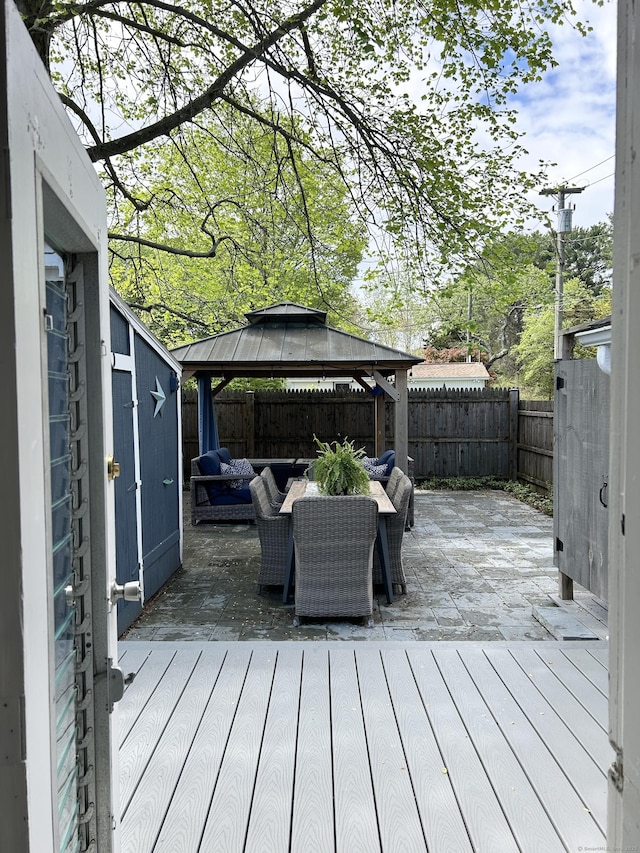1 4th St, Madison, CT 06443 - deck featuring an outdoor living space, a fenced backyard, a gazebo, and a patio area