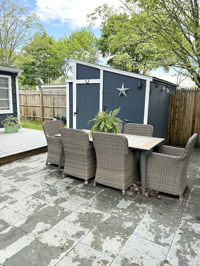 1 4th St, Madison, CT 06443 - fenced backyard featuring outdoor dining space, a shed, a patio, and a wooden deck