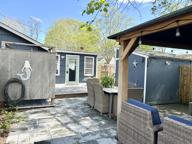 1 4th St, Madison, CT 06443 - view of patio with a deck, a storage unit, and outdoor dining space