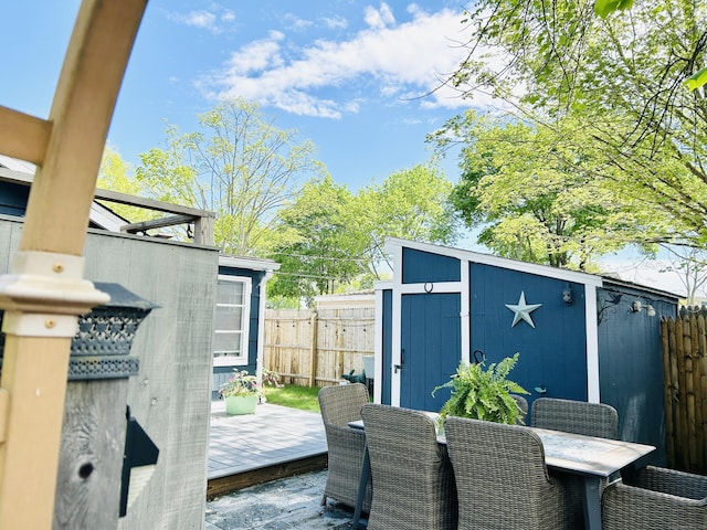1 4th St, Madison, CT 06443 - deck featuring a storage unit, a fenced backyard, and outdoor dining space