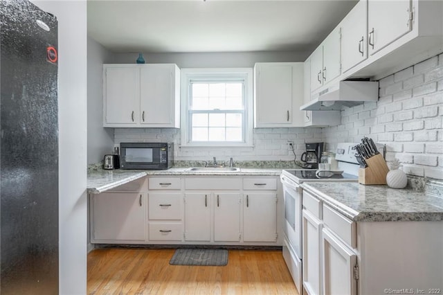 76 Chidsey Dr, North Branford, CT 06471 - kitchen featuring a sink, under cabinet range hood, black microwave, light countertops, and white electric stove