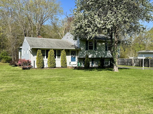 76 Chidsey Dr, North Branford, CT 06471 - tri-level home featuring a shingled roof, a chimney, fence, and a front yard