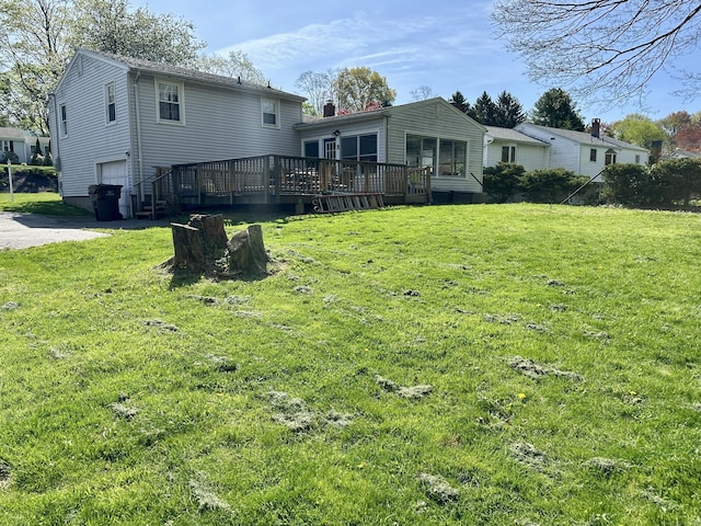 76 Chidsey Dr, North Branford, CT 06471 - back of property with a yard, a wooden deck, an attached garage, and driveway