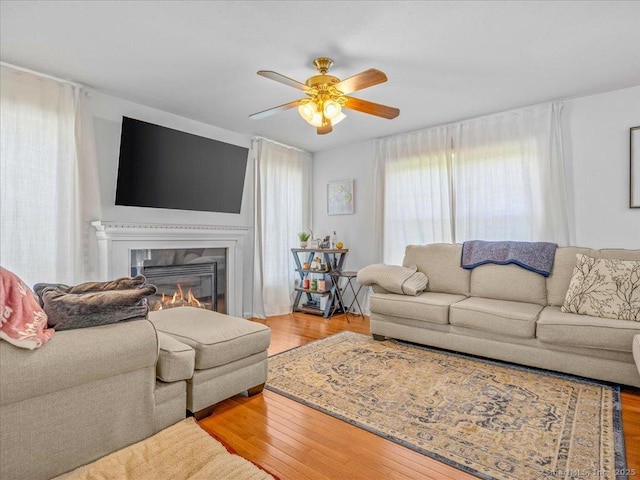 149 Tromley Rd, East Windsor, CT 06088 - living area with a glass covered fireplace, ceiling fan, and wood finished floors