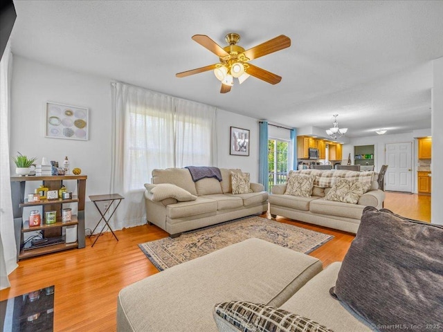 149 Tromley Rd, East Windsor, CT 06088 - living area featuring a chandelier, light wood finished floors, and ceiling fan