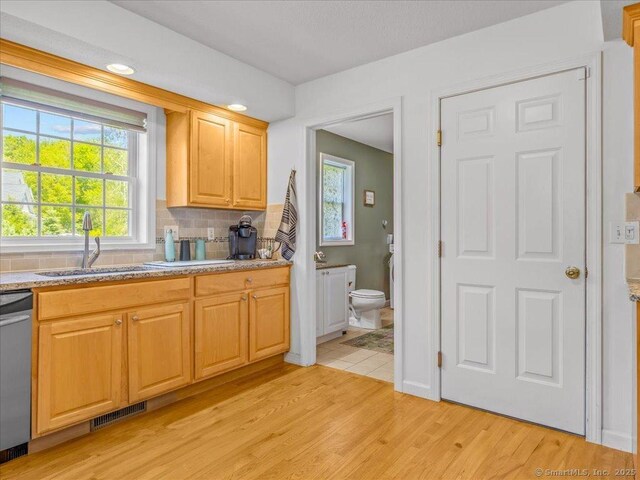 149 Tromley Rd, East Windsor, CT 06088 - kitchen with a sink, stainless steel dishwasher, light wood-type flooring, backsplash, and healthy amount of natural light