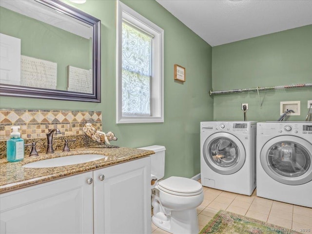 149 Tromley Rd, East Windsor, CT 06088 - bathroom with washing machine and clothes dryer, tile patterned floors, toilet, vanity, and backsplash