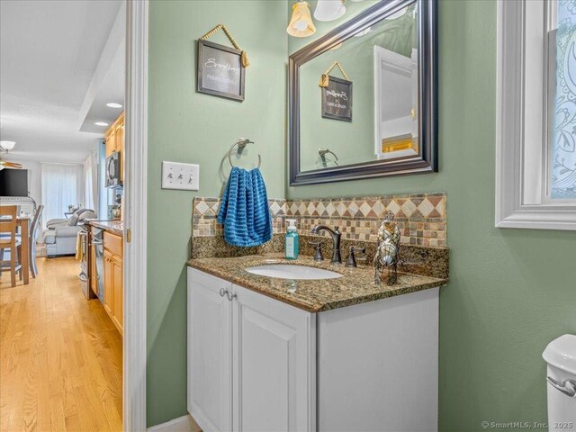 149 Tromley Rd, East Windsor, CT 06088 - half bath with backsplash, vanity, and wood finished floors