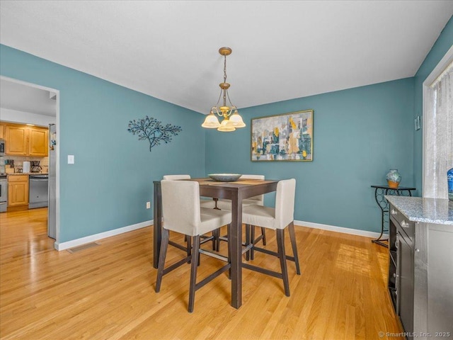 149 Tromley Rd, East Windsor, CT 06088 - dining room with light wood-style floors, a chandelier, and baseboards