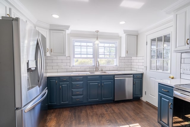 kitchen featuring blue cabinets, stainless steel appliances, light countertops, and white cabinets