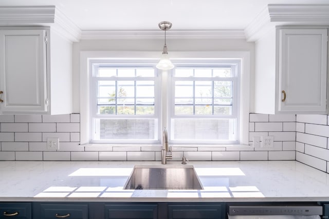 kitchen with a sink, tasteful backsplash, dishwashing machine, a healthy amount of sunlight, and white cabinets