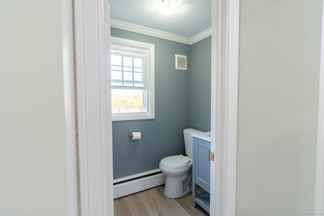 bathroom featuring a baseboard radiator, toilet, visible vents, crown molding, and wood finished floors