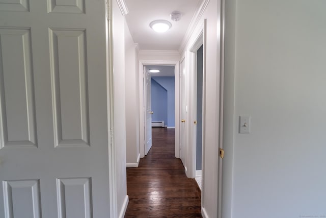 hall with ornamental molding, a baseboard radiator, dark wood finished floors, and baseboards