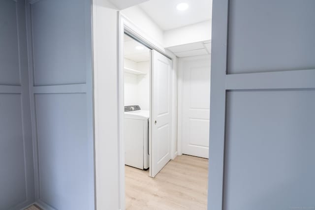 walk in closet featuring washer / clothes dryer and light wood-style flooring