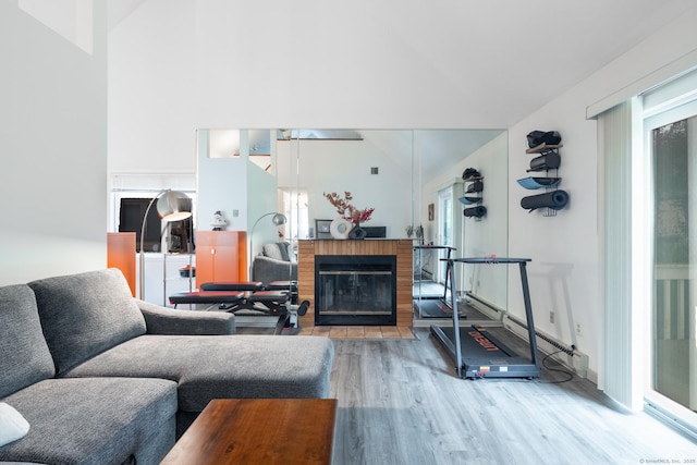 7 Copper Hill Dr Unit 7, Guilford, CT 06437 - living room featuring a fireplace with flush hearth, high vaulted ceiling, and wood finished floors