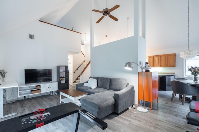 7 Copper Hill Dr Unit 7, Guilford, CT 06437 - living area with light wood finished floors, stairs, ceiling fan with notable chandelier, and high vaulted ceiling