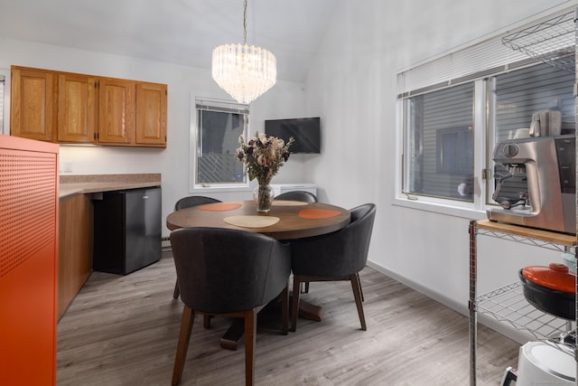 7 Copper Hill Dr Unit 7, Guilford, CT 06437 - dining room with lofted ceiling, light wood finished floors, a chandelier, and a heating unit