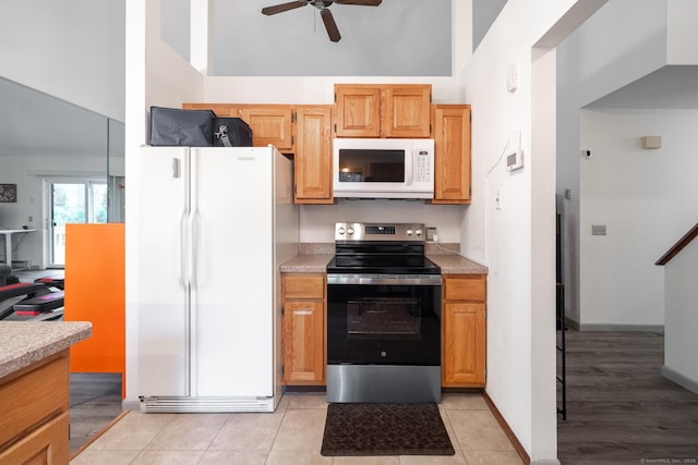 7 Copper Hill Dr Unit 7, Guilford, CT 06437 - kitchen with light tile patterned floors, a ceiling fan, high vaulted ceiling, white appliances, and light countertops