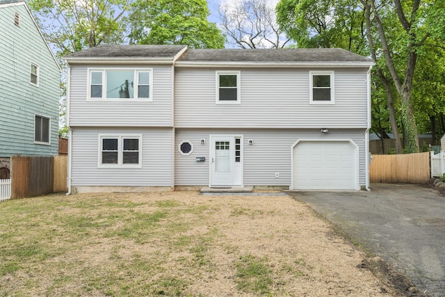 13 Holly St, Norwalk, CT 06851 - colonial-style house with an attached garage and asphalt driveway