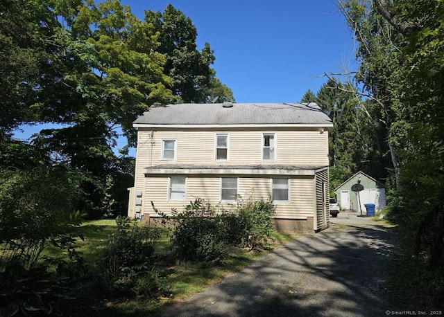 1067 Hartford Tpke, Waterford, CT 06385 - view of property exterior featuring an outdoor structure, driveway, and a shed