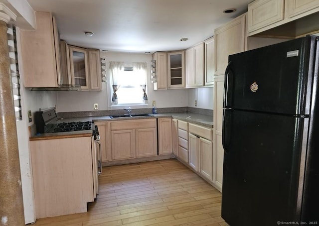 1067 Hartford Tpke, Waterford, CT 06385 - kitchen featuring freestanding refrigerator, light brown cabinets, glass insert cabinets, stainless steel range with gas stovetop, and a sink