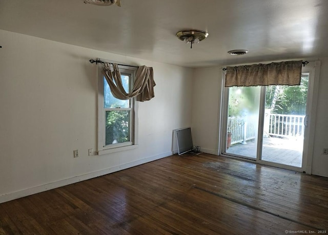 1067 Hartford Tpke, Waterford, CT 06385 - unfurnished room featuring baseboards, visible vents, wood finished floors, and a wealth of natural light